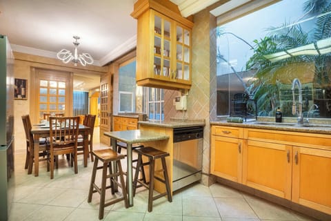 A generous kitchen setup with table and breakfast bar.