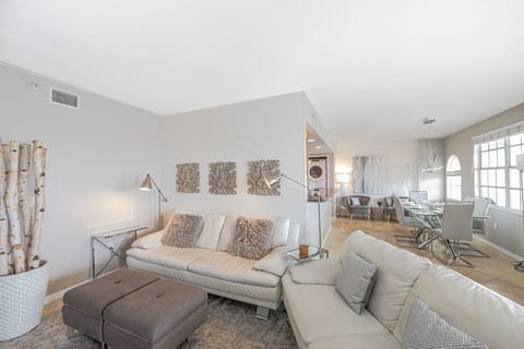 Enjoy the spacious open-plan living room area, complete with a smart TV and breathtaking views of the bay.