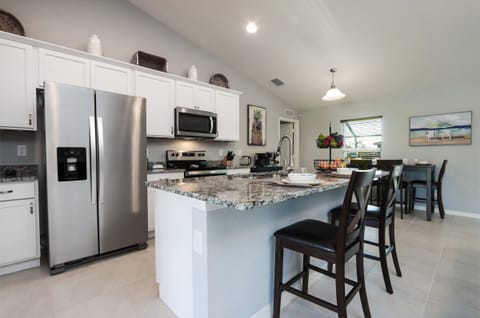 Open-concept kitchen designed for cooking and socializing, complete with stainless steel appliances