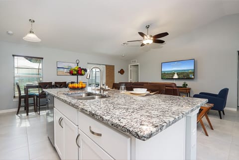 Bright kitchen with an open view of dining and living areas for family-friendly living