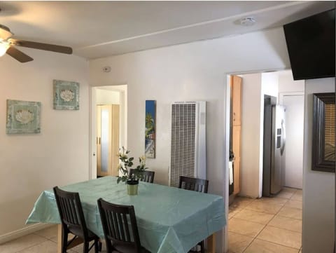 Living room opens to kitchen on right, bedroom and stairwell on left