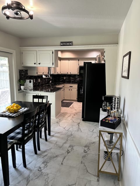 Dining room with ceiling fan, 6 seater dining table with access to backyard.