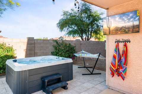 Unwind in the hot tub and enjoy outdoor entertainment with a mounted TV and hammock for ultimate relaxation