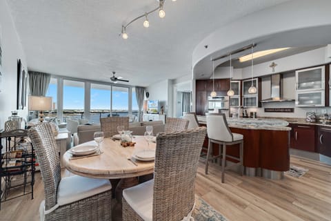 Gather around the elegant dining table, ready for memorable meals and conversations in this beautifully appointed bayfront condo.