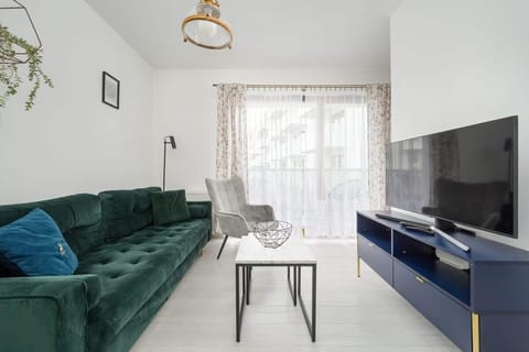 Relax in the stylish living area with a comfortable sofa and modern decor.