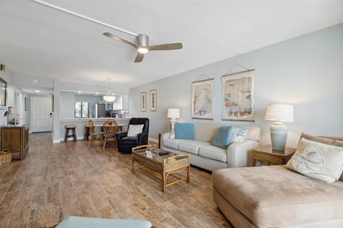 The living room is spacious and has plenty of seating, making it a perfect spot for a relaxing day.