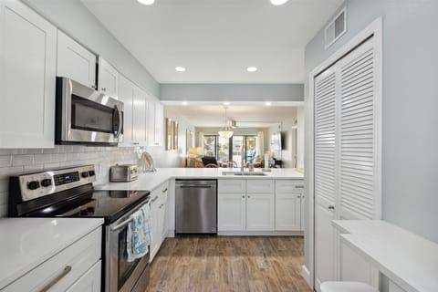 The kitchen is modern and updated, featuring appliances such as a microwave oven, coffee maker, toaster, and refrigerator.