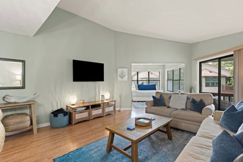This spacious den has tons of seating and a flatscreen TV
