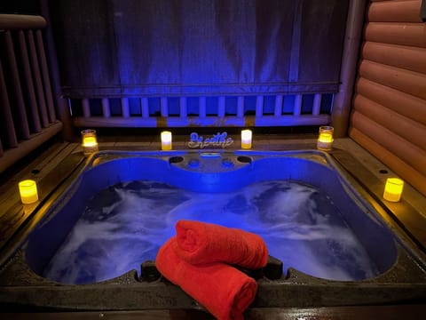 Recessed hot tub on private screened in front porch with privacy blinds