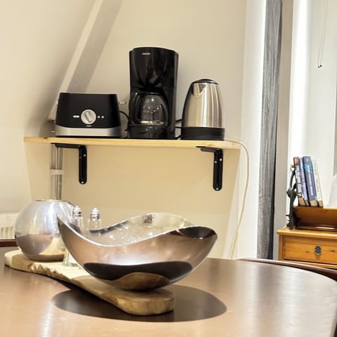 The kitchen has a coffee maker, kettle, blender, and all essential tools.