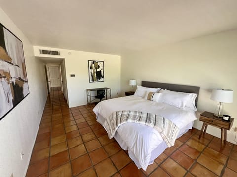 Primary bedroom downstairs - king bed access to backyard and ensuite bathroom