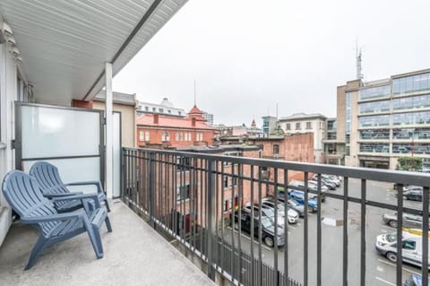 Spacious balcony with cityscape views and seating