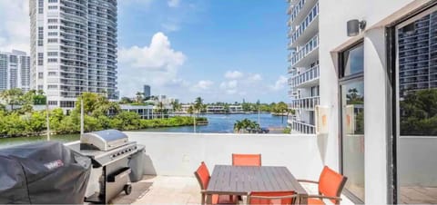 Barbecue with family near pool overlooking inter-coastal