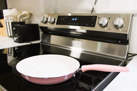 Stove with a pan, there are more pots and pans in the cabinets