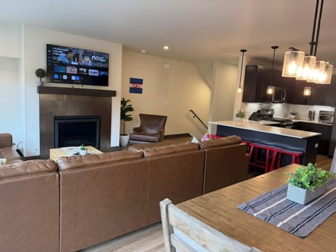 Living area, kitchen, counter eating area, dining area & TV. 