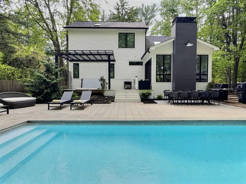 Outdoor area with heated saltwater pool, hot tub, lounge chairs-perfect retreat
