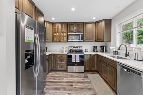 Cook like a pro in the upgraded kitchen—stainless steel appliances, large island, bar seating, forest views, and all the cookware you’ll need.