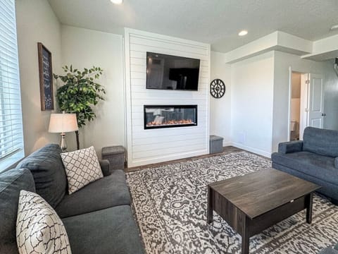 Charming living room with cozy seating, warm fireplace, and soft lighting—perfect for relaxing evenings and quality time with loved ones.