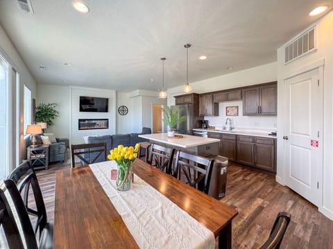 Spacious open-concept kitchen and living area with cozy fireplace, perfect for gathering, relaxing, and enjoying home-cooked meals together.