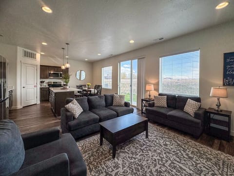 Warm and spacious living area with plush seating, natural light, and open flow—perfect for relaxing or entertaining guests.