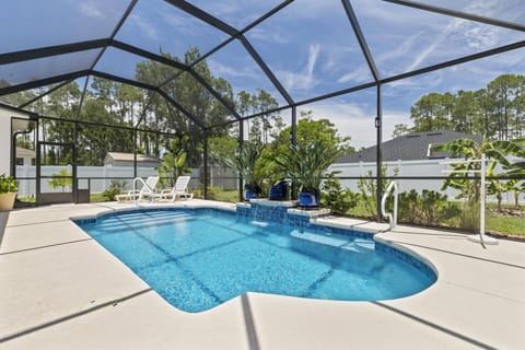 Come relax at Salty Reef Pool Home, featuring a spacious pool area perfect for unwinding. Enjoy a serene atmosphere outdoors and soak up the sun.