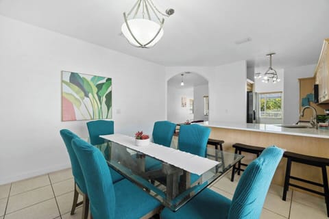 The stylish dining room boasts a vibrant neon sign that sets the tone for cocktail hour. A mini bar cart is available for mixing and serving drinks to you and your guests. The dining area provides seating for 3 at the bar counter and 6 around the dining table.