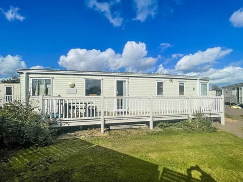Relax on the decking of your caravan at Summerfield Holiday Park after a day spent spotting seals at Horsey Gap on the Norfolk coast.