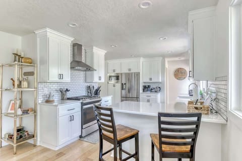 Cook up a storm in this bright, white kitchen! Modern appliances and a stylish island make meal prep a breeze.