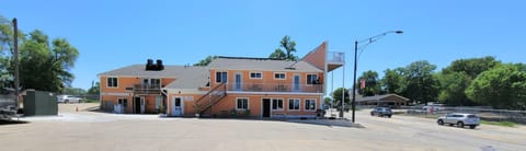 This is the exterior of Stay Suites. There is parking here, south of the building in the grass area, Remax parking lot or Iowa Street. 316 Hwy 71 is a busy area.