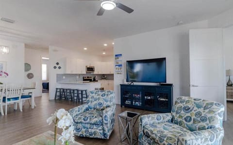 Charming living room decor with comfy seating arrangement and smart TV.