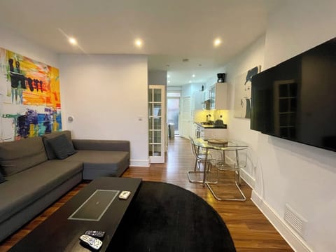 View of open plan living room, dining area and kitchen with patio in the back
