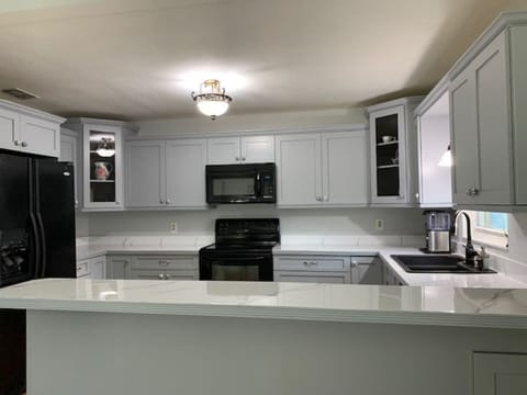 Kitchen with full stove, oven, microwave, fridge/freezer