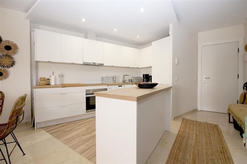 View of the modern open kitchen in this apartment