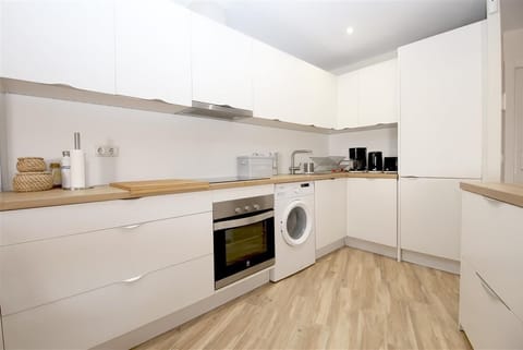 Modern open kitchen is fully fitted with all the appliances
