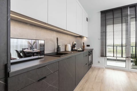 The sleek design of the kitchenette blending seamlessly with the living area.