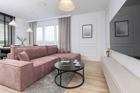 Relax in the stylish living room with a comfortable sofa and modern decor.