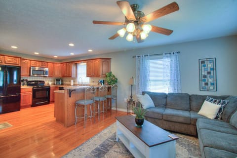 Cozy living room with a plush sofa and a charming view of the kitchen.