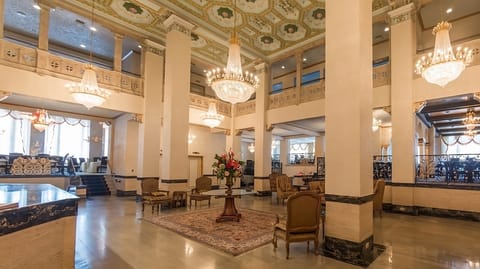 Step into a grand lobby sparkling with chandeliers and space.