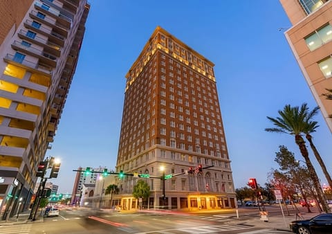 Arrive in style at a landmark tower glowing at dusk.