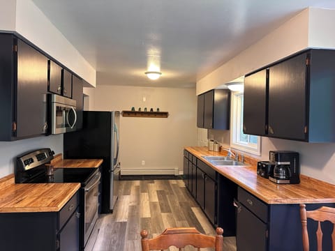 Large, fully-stocked kitchen.
