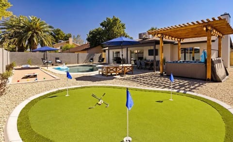 Enjoy the putting green in the beautiful backyard.
