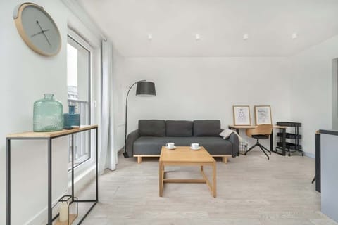 A cozy bedroom area with a comfortable bed and soft lighting, perfect for rest and relaxation. The room features modern decor and a small shelf for added convenience.