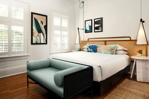 Unwind in a sunlit bedroom with stylish lounge seating.