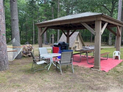Steps away from covered common area with shared propane grill, games and tables