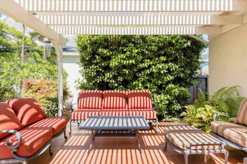 A covered patio just off the family room provides extended living space allowing our guests to enjoy the backyard.  There is a couch, loveseat, club chair, ottoman and coffee table on the patio.  Please replace the furniture covers when not in use.
