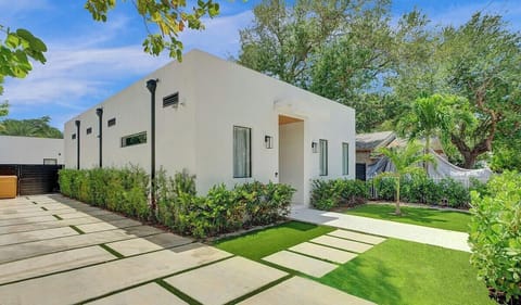 Front entrance with a private gated yard and driveway for parking