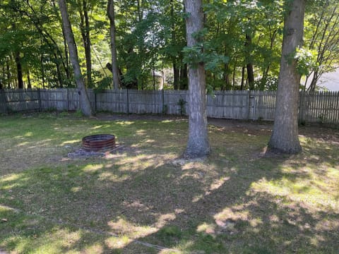 Spacious fenced in backyard with fire pit. *Please only burn wood*