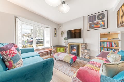 The cosy front room is light and bright, the perfect space for everyone to relax
