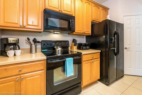 Tranquil Kitchen of the condo in Orlando Florida - Modern kitchen with sleek, stainless steel appliances - Contemporary design with clean lines and minimalist aesthetics - Integrated appliances for a seamless and stylish look - Plenty of storage