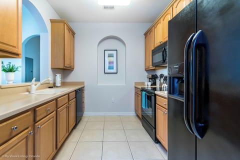 Polished kitchen of the condo in Orlando Florida - Thoughtful placement of kitchen essentials for easy access - Harmonious blend of practicality and contemporary aesthetics